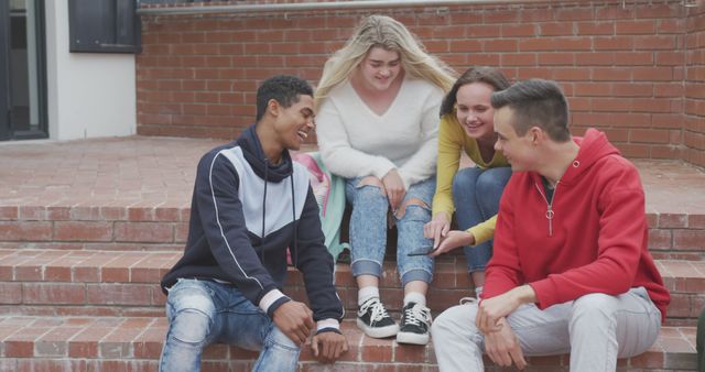 Teenagers Sitting on Steps Sharing and Smiling - Download Free Stock Images Pikwizard.com