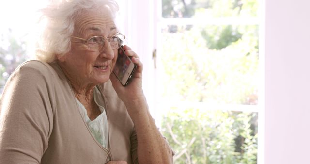 Senior Woman Talking on Smartphone in Bright Room - Download Free Stock Images Pikwizard.com