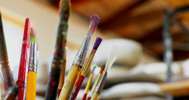 Close-up of various paint brush in pencil holder in pottery worktop 4k