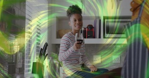 Happy Woman Relaxing in Modern Kitchen with Wine