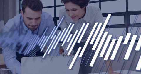 Business professionals analyzing laptop analytics with digital data overlay in office