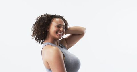 Joyful Plus Size Woman Posing with Curly Hair in Studio