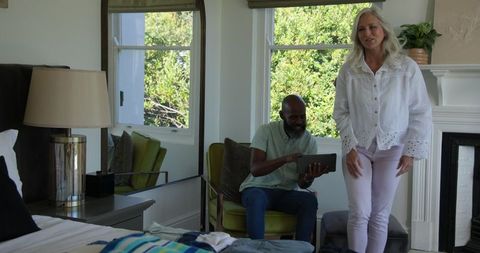 Seniors Enjoying Technology Together in Bright Living Room