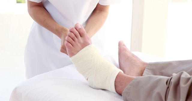 Nurse Treating Patient with Bandaged Foot in Medical Clinic - Download Free Stock Images Pikwizard.com