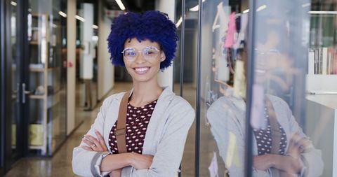 confident young businesswoman smiling in modern office corridor - Download Free Stock Images Pikwizard.com