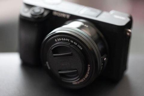 Close-up of technology digital camera on black surface