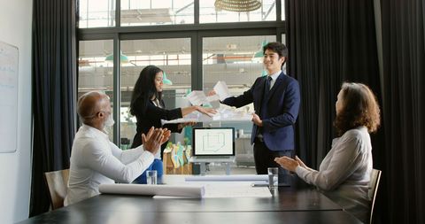 Diverse Team in Office Meeting Exchanging Documents