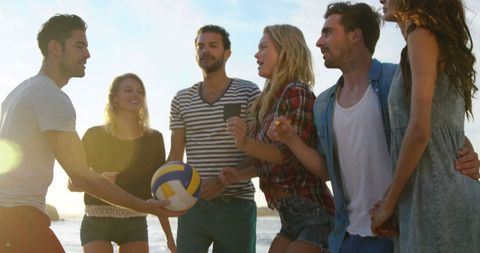 Group of Friends Enjoying Beach Volleyball at Sunset - Download Free Stock Images Pikwizard.com