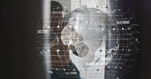 Businessman standing watching holographic globe projecting global data on glass panel