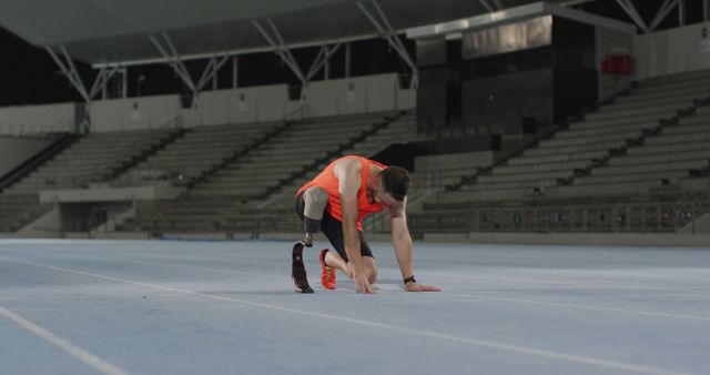 Caucasian disabled male athlete with running blade suffering from exhaustion. professional runner training at sports stadium.