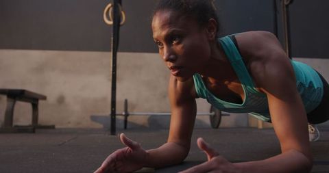 Athletic woman in plank position at gym