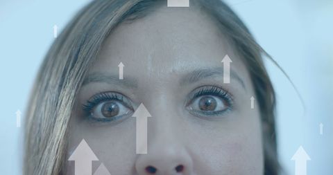 Confident businesswoman looking ahead with digital arrows overlay