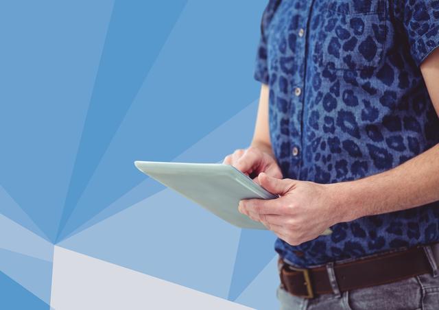 Man wearing casual denim shirt with leopard print, using tablet device against an abstract blue geometric background. Perfect for technology ads, modern lifestyle, or educational content.