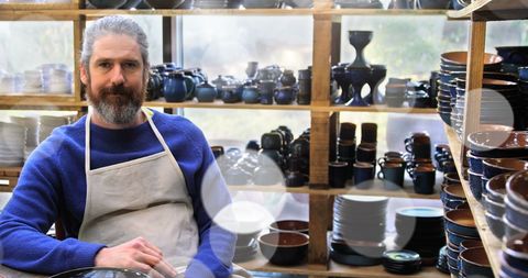Potter in Workshop Surrounded by Traditional Ceramics