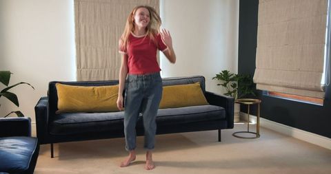 Joyful Teen Dancing in Living Room, Expressing Happiness