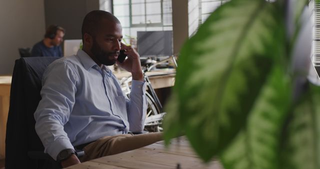 Businessman Having Phone Call at Office Desk - Download Free Stock Images Pikwizard.com