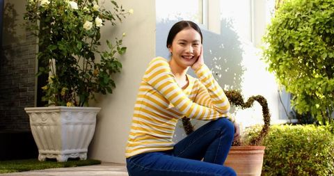 Smiling Woman on Garden Patio Relaxing Outdoors