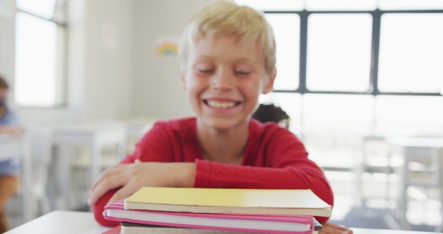 Smiling Caucasian Boy in Classroom with Books - Download Free Stock Images Pikwizard.com