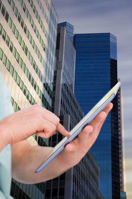 Man using digital tablet in front of modern city buildings, showcasing corporate and urban environment. Ideal for technology, business, innovation, and modern lifestyle themes. Useful for illustrating connectivity, professional work, and digital progress in an urban setting.