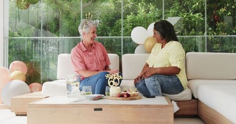 Joyful Senior Couple Celebrating Birthday at Home with Balloons