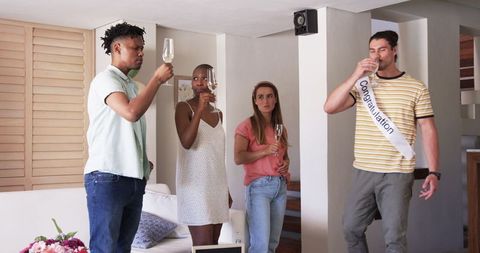 Friends Toasting Champagne at Home Celebration Gathering
