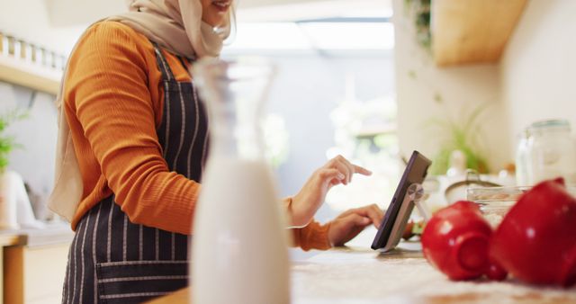 Woman in Hijab Using Tablet for Cooking in Modern Kitchen - Download Free Stock Images Pikwizard.com