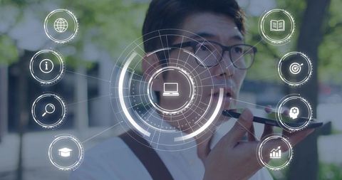 Asian man speaking into smartphone wearing glasses with holographic laptop interface