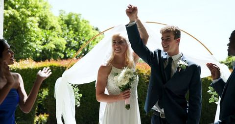 Joyful Newlyweds Celebrating with Multiracial Witnesses Outdoor Ceremony