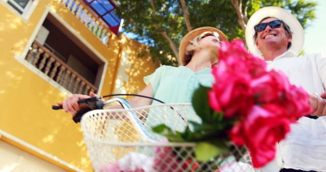 Happy Couple Enjoying Sunny Day with Bicycle and Flowers - Download Free Stock Images Pikwizard.com