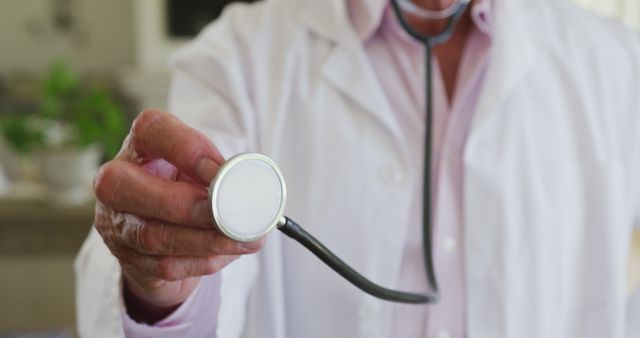 Doctor in White Lab Coat Holding Stethoscope Close-Up - Download Free Stock Images Pikwizard.com