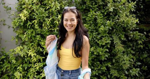 Joyful Woman Posing Against Lush Foliage