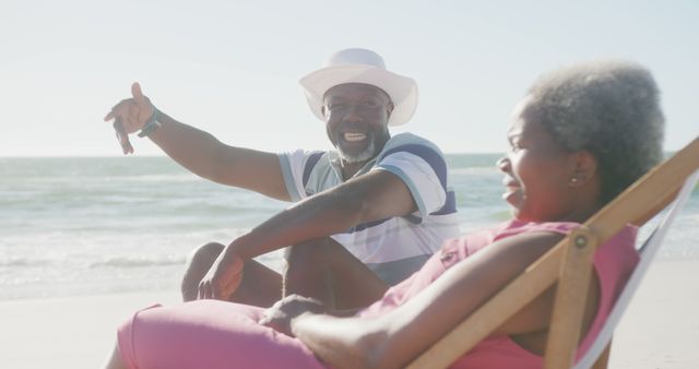 Joyful Couple Relaxing on Beach in Bright Sunlight - Download Free Stock Images Pikwizard.com