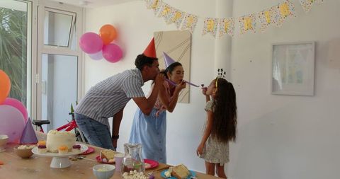 Family enjoying birthday celebration with cake and party decorations