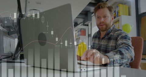 Businessman Analyzing Market Data on Laptop in Modern Office