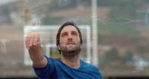 Man reaching toward holographic interface outdoors amid futuristic data streams
