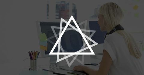 Woman Sketching with Graphics Tablet in Modern Office Workspace