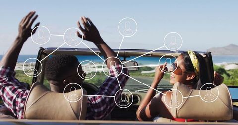 Couple enjoying drive with connectivity theme on coastal road