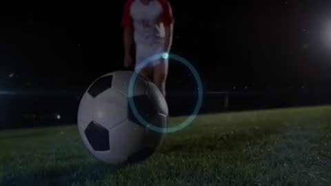 Soccer Player Approaching Ball on Field at Night with Dynamic Lighting