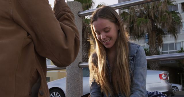 Smiling Young Woman Outdoors with Friend on Sunny Day - Download Free Stock Images Pikwizard.com