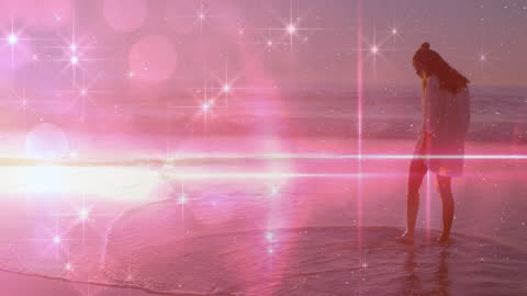 Serene Woman Walking Along Beach at Sunset with Lens Flare Effects