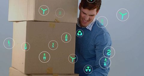 Man lifting stacked cardboard boxes with green logistics icons showing exertion