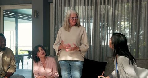 Diverse Group Engaging in Therapy Session with Asian Female Therapist