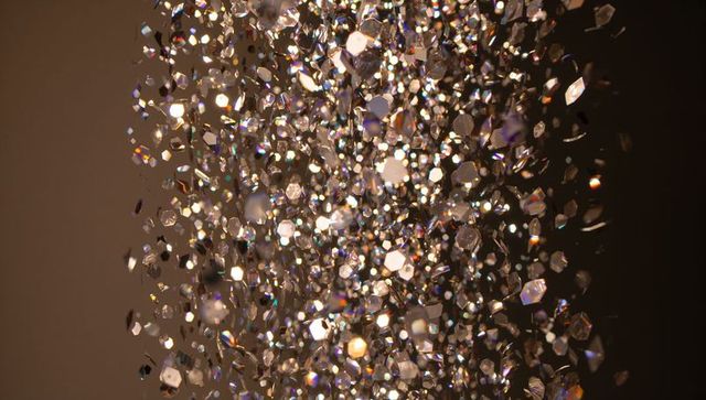 Shimmering faceted crystal column with prism glints and soft bokeh macro, luxury holiday