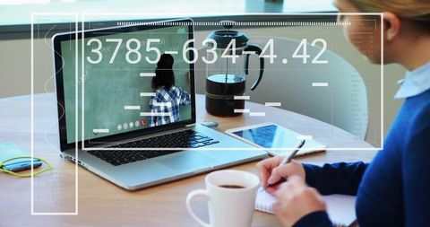 Person Participating in Virtual Class Taking Notes with Laptop