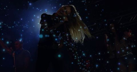 Dynamic Singer Performing Energetic Show under Blue Confetti