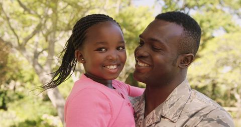 Father in Uniform Holding Daughter Outdoors with Joyful Embrace - Download Free Stock Images Pikwizard.com