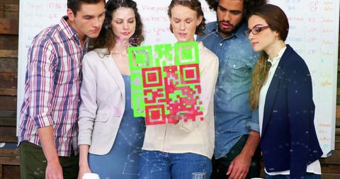 Colleagues Analyzing Holographic QR Code in Innovative Office