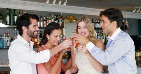 Friends Enjoying Celebration at Trendy Bar Setting - Download Free Stock Images Pikwizard.com