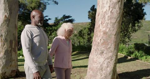 Senior Couple Strolling Peacefully Through Scenic Park