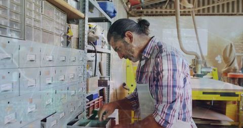 Craftsman Organizing Workshop Supplies in Productive Workspace